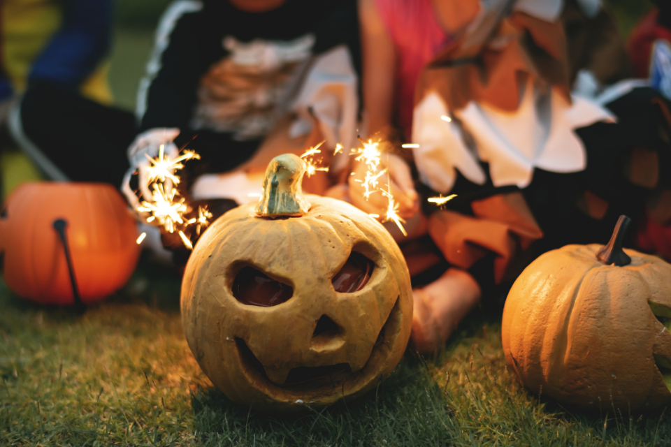 kids playing around pumpkins