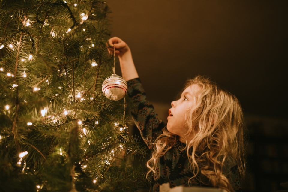 Little girl decorating Christmas tree